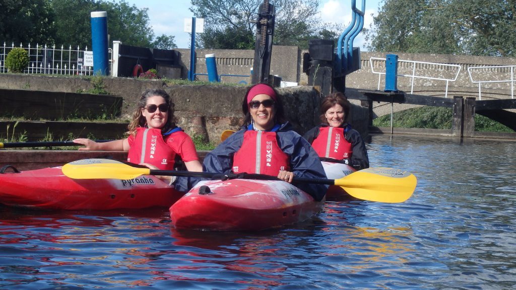 A number of ladies trying out canoeing for the first time
